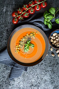 Tomato and carrot soup topped with chopped pistachios