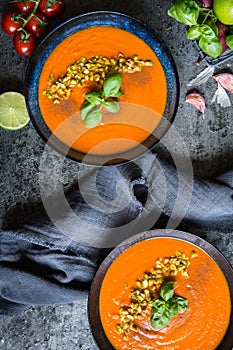 Tomato and carrot soup topped with chopped pistachios