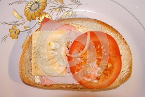 Tomato , cheese and ham sandwich as breakfast food