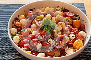 tomato and cheese salad in a bowl