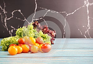 Tomato cherry with green and red leaf lettuce on top wooden table. Fresh ingredient for making healthy salad and sandwiches