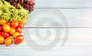 Tomato cherry with green and red leaf lettuce on top wooden table. Fresh ingredient for making healthy salad and sandwiches