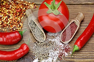 Tomato, Chili Pepper, Salt And Pepper On Rustic Wood Table