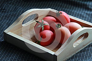 tomato color on wood tray.