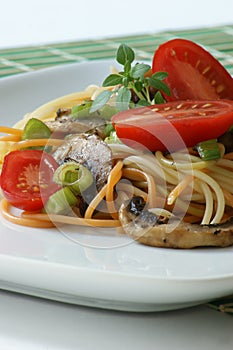 Tomato and colored spaghetti with mushroom