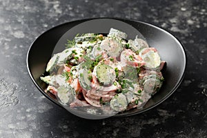 Tomato cucumber salad with dill, spring onion and sour cream