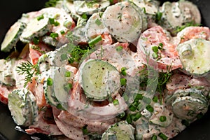 Tomato cucumber salad with dill, spring onion and sour cream
