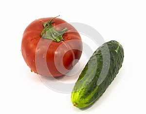 A tomato and a cucumber in a white background
