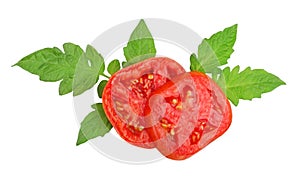 Tomato cut, in circles, on leaves, top view, isolated on a white background