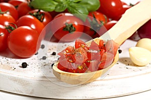 Tomato cut on wooden spoon