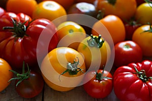 Tomato of different varieties on a wooden background