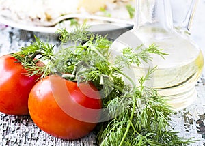 Tomato, dill on the wooden table