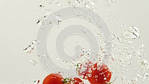 Tomato drop in water splash with bubble in slow motion