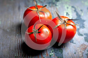 Tomato with drops. Full depth of field. Fresh red ripe tomatoes for use as cooking ingredients in the foreground with