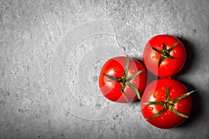 Tomato with drops. Full depth of field. Fresh red ripe tomatoes for use as cooking ingredients in the foreground with