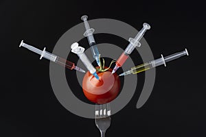 tomato filled with syringes. High quality photo
