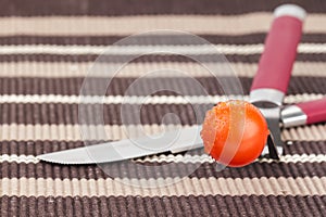 Tomato, fork and knife