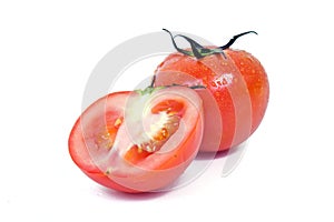 Tomato fruit with half cross section isolated on white background