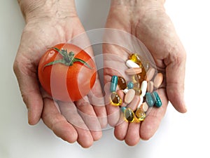 Tomato and handfull of pills photo