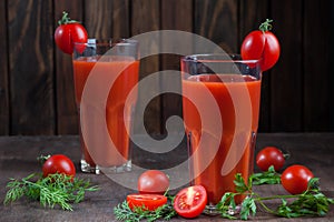 Tomato juice on dark wooden background