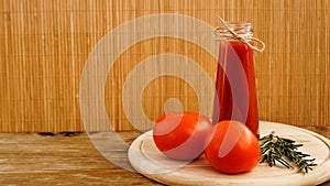 Tomato juice, fresh tomatoes on wooden background horizontal