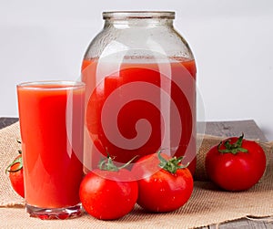 Tomato juice in glass and two liter jar