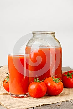 Tomato juice in glass and two liter jar