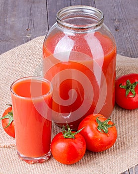 Tomato juice in glass and two liter jar