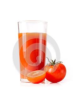 Tomato juice in a tall glass glass with natural fresh tomatoes on a white background