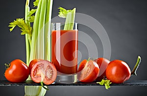 Tomato juice with tomatoes and celery sticks