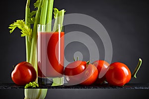Tomato juice with tomatoes and celery sticks