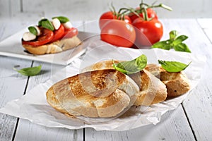 Tomato, mozzarella cheese, basil bruschetta wood on the table