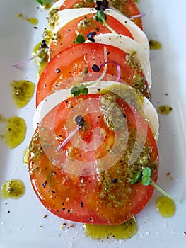 Tomato Mozzarella salad close up with pesto
