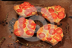 Tomato Mozzarella Toast on metal pan. Sandwich toasts with tomatoes, mozzarella and basil leaves