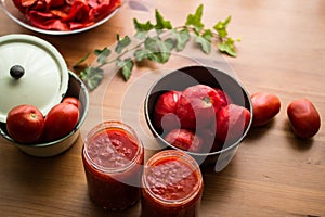 Tomato Paste on a wooden surface with concept backround.