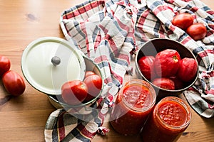 Tomato Paste on a wooden surface with rustic tablecloth.