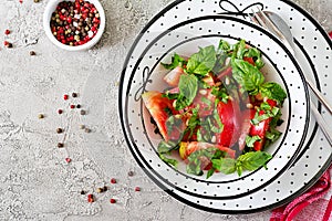 Tomato salad with basil and pine nuts in bowl - healthy vegetarian vegan diet organic food appetizer.