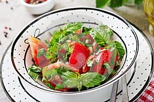 Tomato salad with basil and pine nuts in bowl - healthy vegetarian vegan diet organic food appetizer.