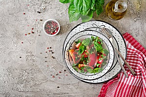 Tomato salad with basil and pine nuts in bowl - healthy vegetarian vegan diet organic food appetizer.