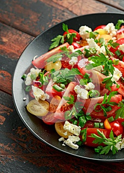 Tomato salad with feta cheese, spring onion and parsley. Healthy summer food