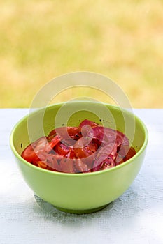 Tomato salad in green bowl