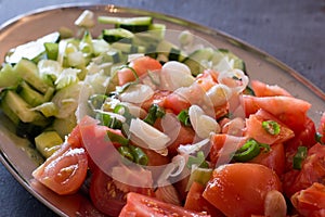 Tomato salad with onion, chive and cucumber