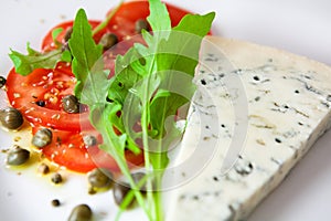Tomato salad and a slice of gorgonzola photo
