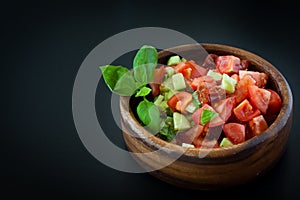 Tomato salad in a wooden bowl