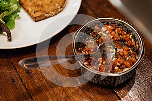 Tomato Salsa Sauce prepare for pasting toast in slainless steel cup with spoon