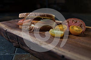 Tomato Sandwich in softlight on wooden cutting board