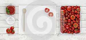 tomato sauce above, cutting board with spoon, glass jar and tomatoes isolated on white wooden kitchen worktop background, copy sp