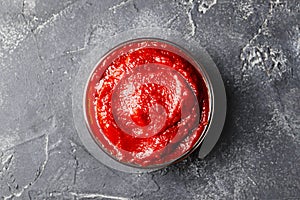 Tomato sauce in a bowl on a dark