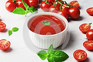 Tomato sauce in a bowl, Fresh basil and fresh cherry tomatoes. Ingredients for the sauce.