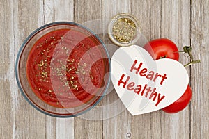 Tomato sauce in clear bowl with oregano spice and red vine ripe